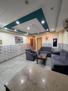a large living room with couches and a table at Jd apartment in Kariāla Railroad Station