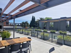 an outdoor patio with a wooden table and chairs at Al lado de la playa, restaurantes y el WTC in Montevideo