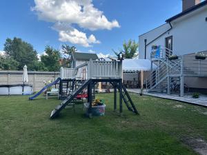a playground with a chair and a slide at Nowy Zakątek in Kobyla Góra