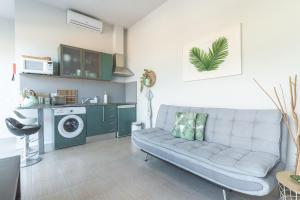 a living room with a couch and a washing machine at Pitanga by Atlantic Holiday in Panasqueira