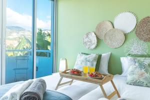 a room with a tray of fruit and drinks on a bed at Pitanga by Atlantic Holiday in Panasqueira +10 photos