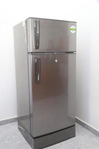 a stainless steel refrigerator in a corner of a room at Tropical apartment no 7 in Nugegoda