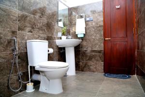 a bathroom with a toilet and a sink at Tropical apartment no 7 in Nugegoda