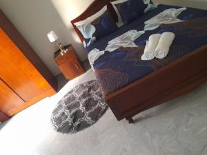 a bedroom with a bed with two pairs of slippers at Tropical apartment no 7 in Nugegoda