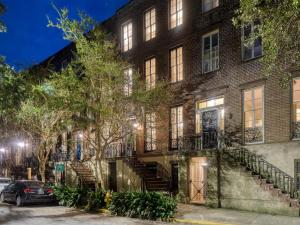 a brick building with stairs in front of it at Gordon Inn Live Oak in Savannah