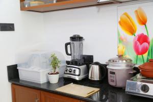 a kitchen counter with a blender and other appliances at Tropical apartment no 7 in Nugegoda +6 photos