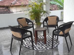 three chairs and a table on a patio at Tropical apartment no 7 in Nugegoda