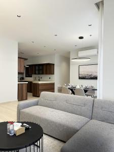 a living room with a couch and a dining room at Mabaat-Executive 3BR-Al Narjis - 619 in Riyadh