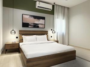 a bedroom with a large bed and a ceiling fan at Mabaat-Executive 3BR-Al Narjis - 619 in Riyadh