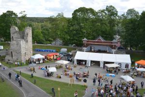 a crowd of people walking around a market in front of a castle at Parkal Apartments in Paide