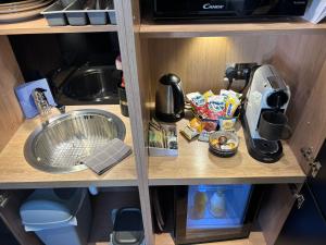 a kitchen counter with a sink and a mixer at Hillside Farm Barn in Woking +29 photos