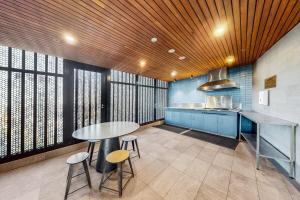 a kitchen with a table and stools in a room at Once Upon a View with Balcony Pool and Parking Level 33 in Brisbane