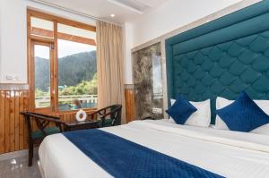 a bedroom with a large bed with a blue headboard at Tara Van in Dharamshala