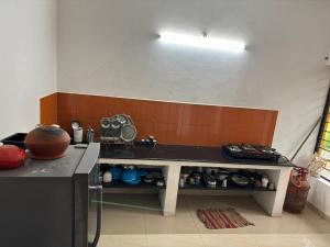 a kitchen with a counter with a table in it at Purity Stay by Crib Community in Auroville