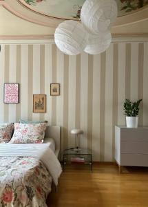 a bedroom with a bed and a table and a chandelier at Steps To Best Bern Sites And Lots Of Space Too! in Bern