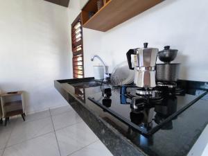 a kitchen counter top with a coffee maker on it at Chalé Bella Vista in Mulungu