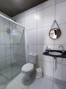 a bathroom with a toilet and a shower and a sink at Chalé Bella Vista in Mulungu +19 photos