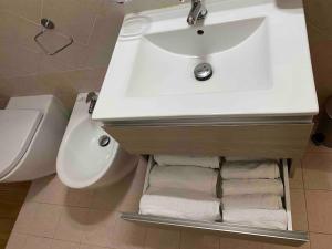 a bathroom with a sink and a toilet at Modern apartment - Salento Guest House in Monteroni di Lecce +11 photos