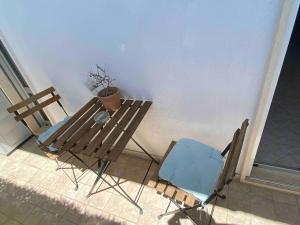 a table and a chair sitting on a patio at Modern apartment - Salento Guest House in Monteroni di Lecce