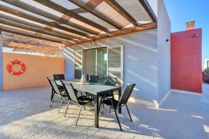 a patio with a table and chairs on it at Aurea Luxury House in Antigua