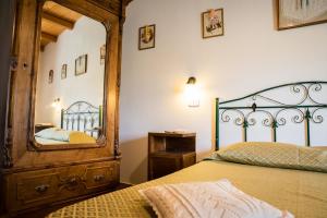 a bedroom with a large mirror and a bed at Acquasalsa in Agnone
