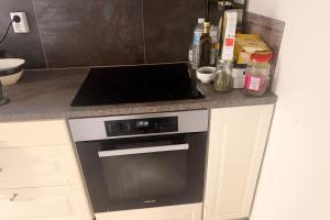 a kitchen with a black and white stove top oven at Cozy private house with free parking in Kongsvinger