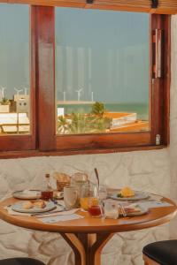 a table with food on it in front of a window at Amana Icaraizinho in Amontada