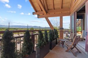 a patio with a table and chairs on a balcony at RMR: Crystal Springs 401 Condo in Teton Village in Teton Village