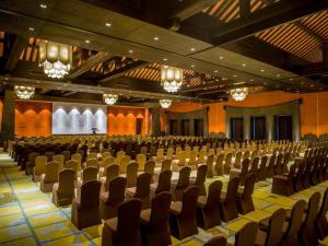 an auditorium with chairs and a stage in the background at Legacy Yen Tu - MGallery in Uông Bí +113 photos