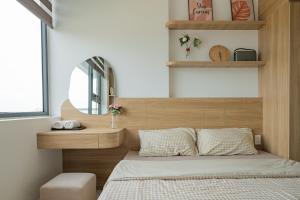 a small bedroom with a bed and a mirror at Hue Rustic Homestay with Swimming Pool & Gym Room in Thôn Văn Dương +29 photos