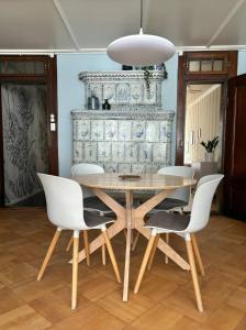 a dining room with a wooden table and white chairs at Steps To Best Bern Sites And Lots Of Space Too! in Bern