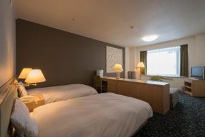 Кровать или кровати в номере Hotel Tangram