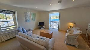 a living room with a couch and chairs and a television at Pennant in Saint Mawes