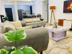 a living room with two couches and a table at 2Bedrm apartment in westlands in Nairobi +8 photos