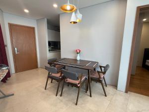 a dining room table and chairs with a vase on it at Vortex klcc lotus in Kuala Lumpur