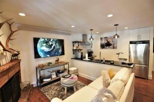 a living room with a couch and a kitchen at RMR: Spruces 13 - The Elks Condo in The Aspens in Wilson