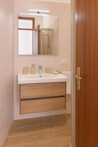 a bathroom with a sink and a mirror at Wald Haus Tarvisio in Tarvisio +11 photos