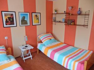 レーアにあるFerienwohnung Sonnenblumeのオレンジと白の壁の客室で、ベッド2台が備わります。