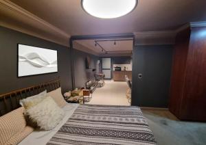 a bedroom with a bed and a living room at Oceans Deep at Lagoon Terrace - Knysna! in Knysna