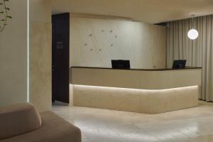 a lobby with a reception desk with avertisement at Mana Suites & Sea SPA in Palanga