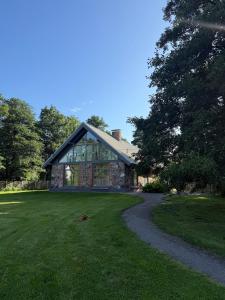 a house with a path in front of it at Design stone villa nearby the Baltic sea, 4BR, 5BA in Skulte