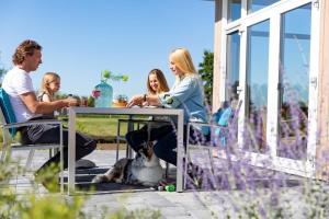 a group of people sitting at a table with a dog at Parc de IJsselhoeve in IJssellaan +18 photos