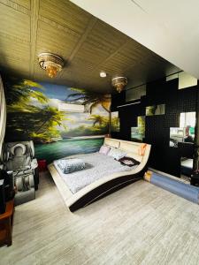 a bedroom with a bed and a painting on the wall at Satymev Serene flats in Ahmedabad