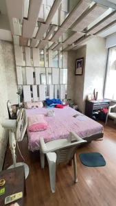a bedroom with a bed and a desk and a chair at Satymev Serene flats in Ahmedabad