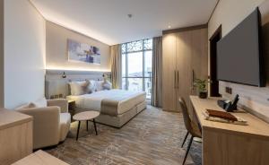 a hotel room with a bed and a television at فندق عمرية in Al Madinah