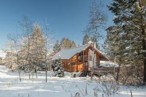 a log cabin in the woods in the snow at RMR: Stock House in Teton Village in Teton Village