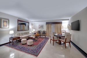 a living room with a couch and a table at Pearl Continental Hotel, Karachi in Karachi