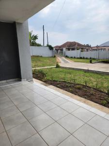an empty patio with a view of a yard at Liwundlu Nest in Matsapha