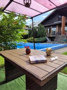 a wooden table with a book on top of it at Studija viloje in Pakopi