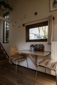 a table and chairs in a room with a window at Tiny House Alba - ervaar tiny house living in Diessen +28 photos